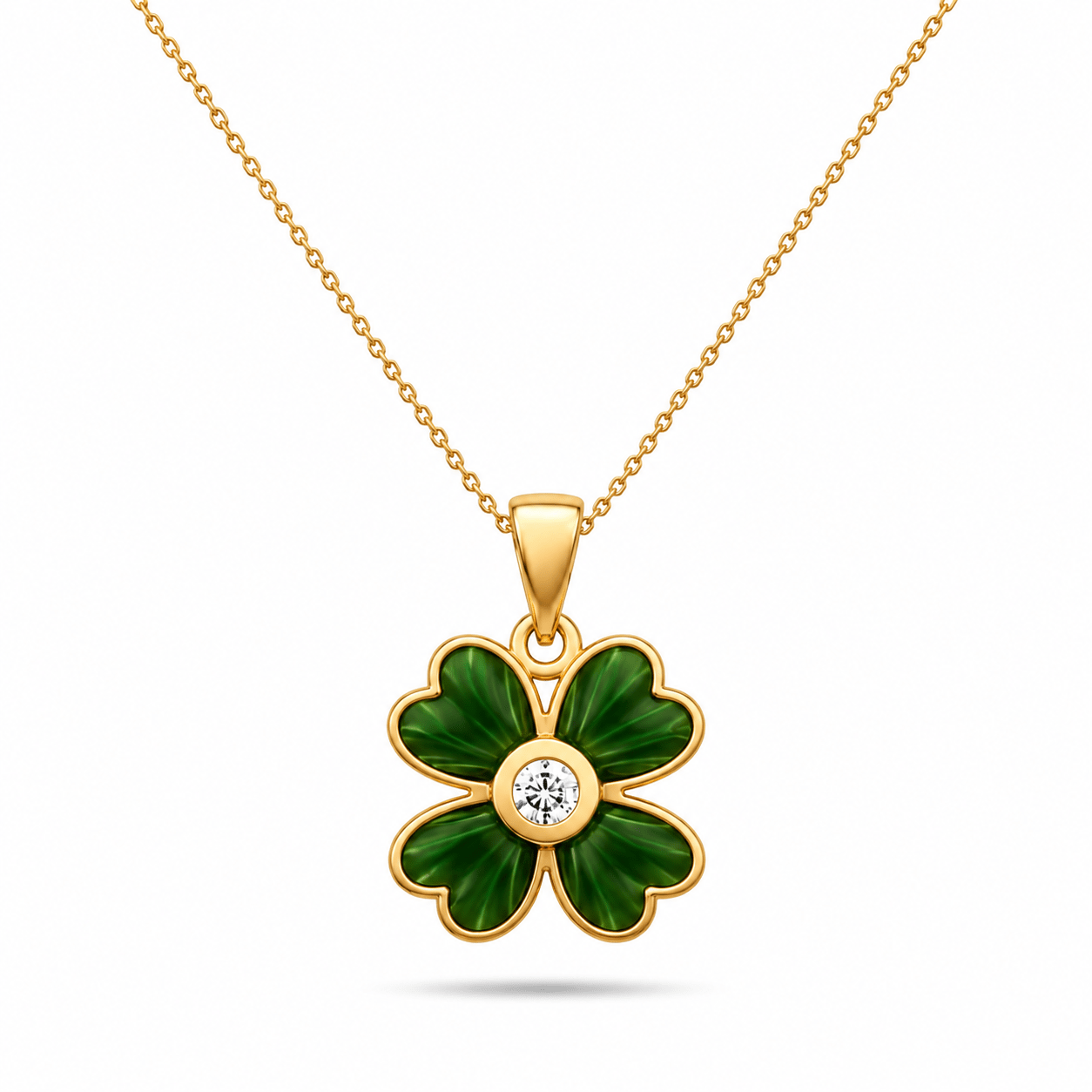 Close-up of the detailed green enamel and central cubic zirconia on the 14ct yellow gold clover pendant by Kolié