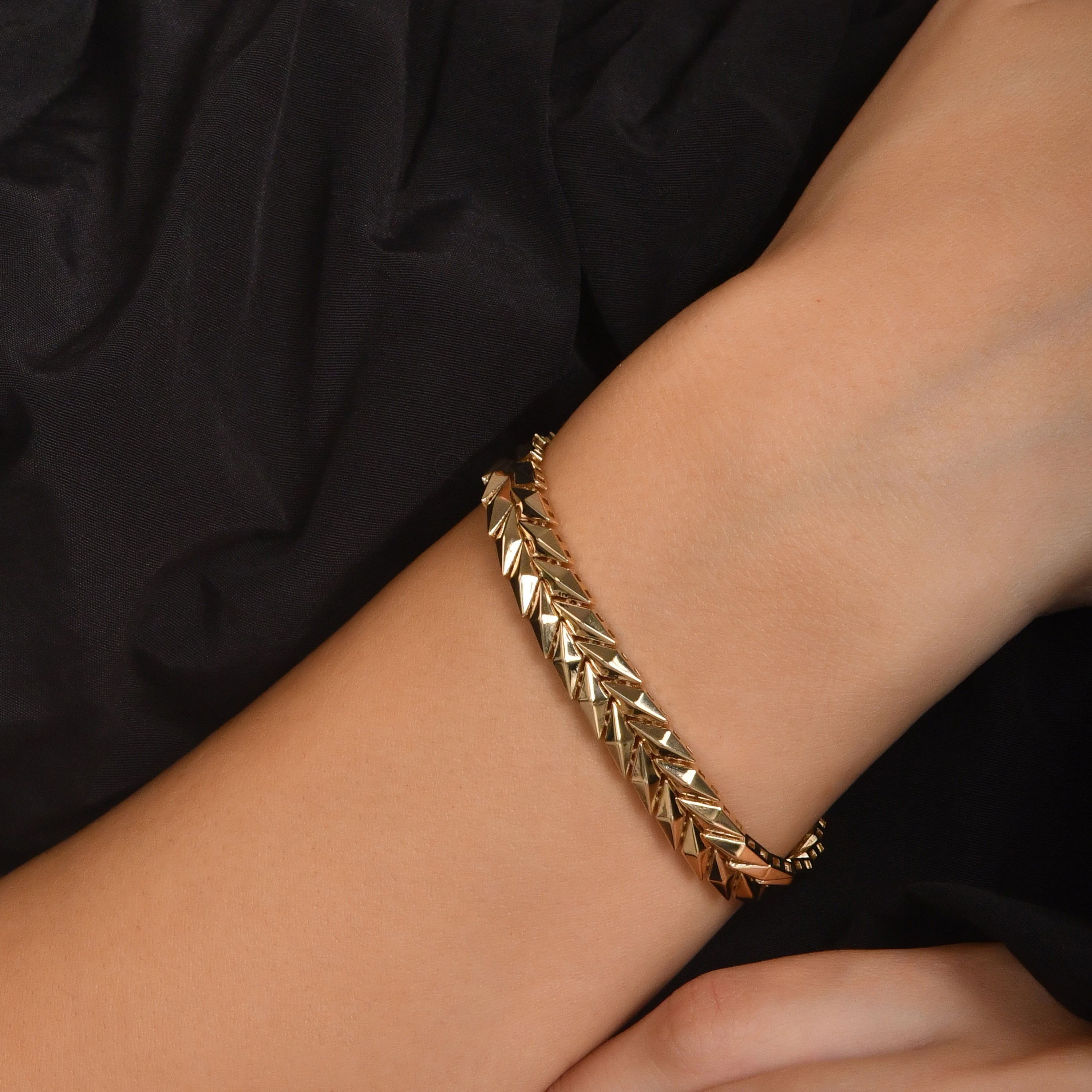 14ct gold geometric link bracelet with polished finish and secure clasp, hallmarked by the Edinburgh Assay Office worn by a model