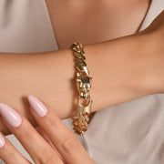 Model wearing gold panther bracelet on wrist showing scale and high polish finish.
