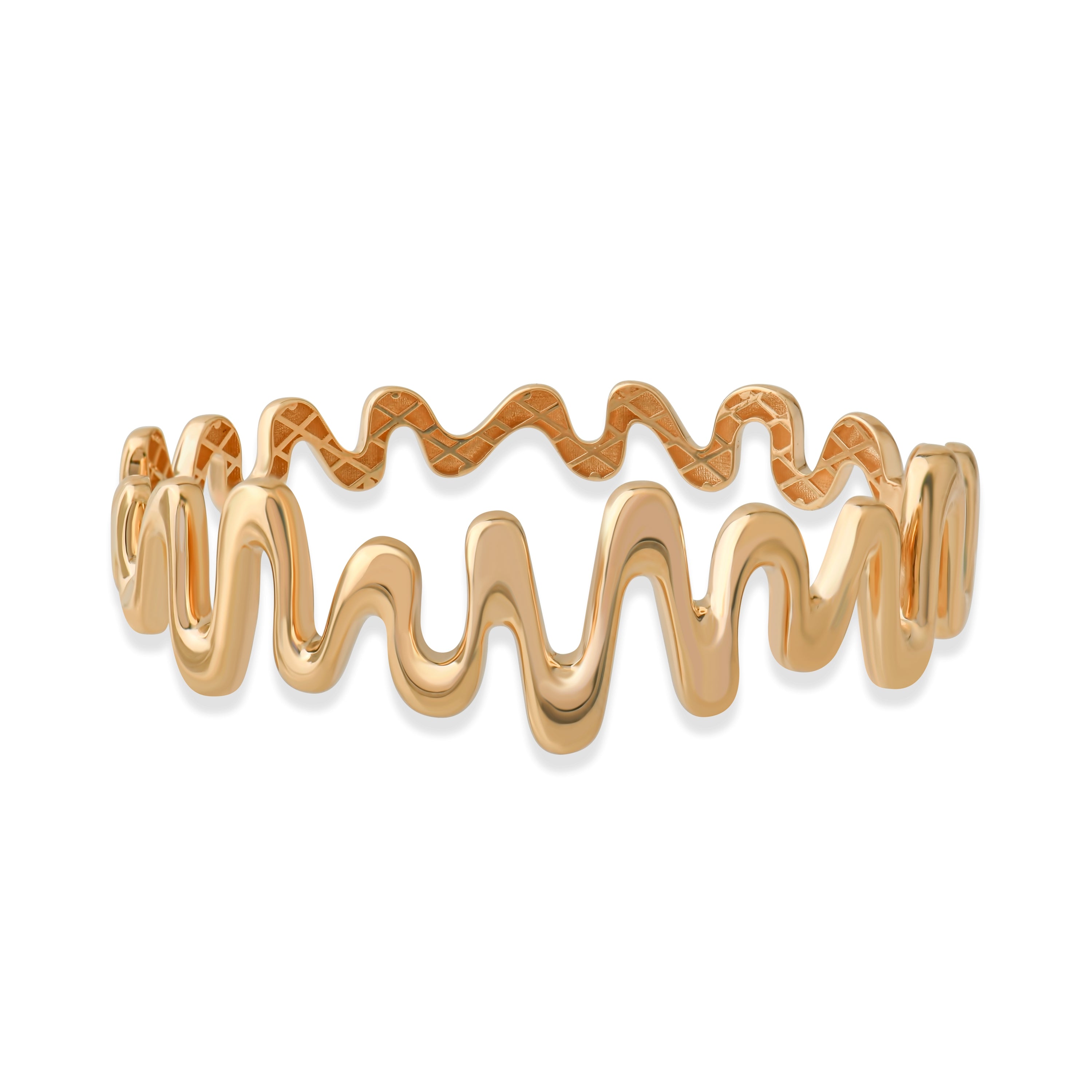 Close-up of wavy gold cuff bracelet on white background