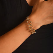 Woman wearing hallmarked 14ct solid gold zigzag bangle on wrist