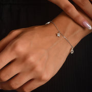 9ct white gold charm bracelet with CZ star and heart charms on model’s wrist
