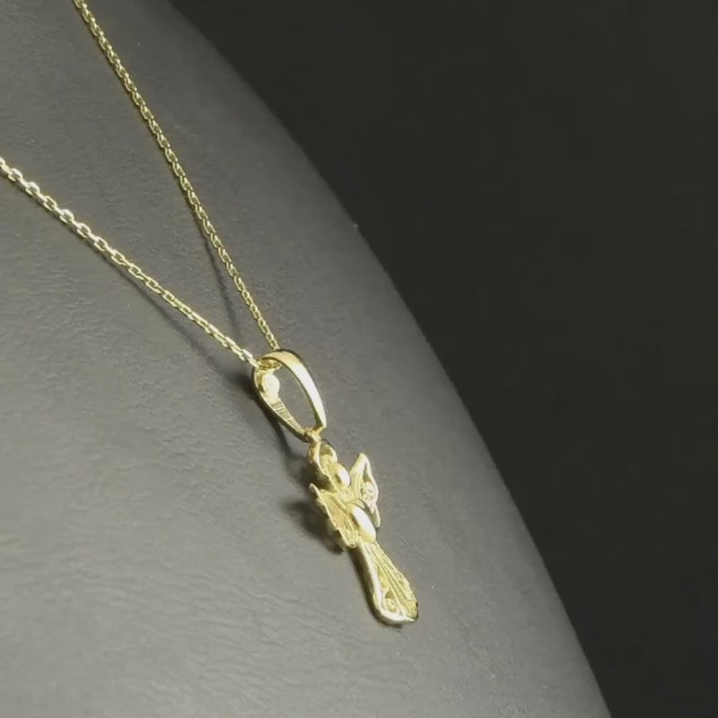 The 14ct gold angel pendant to show its size and design details