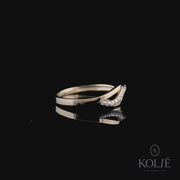 Stylish Kolié 9ct yellow gold ring showcasing a crossover design with a band of shimmering cubic zirconia