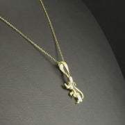 Video of mouse pendant necklace displayed on a black background