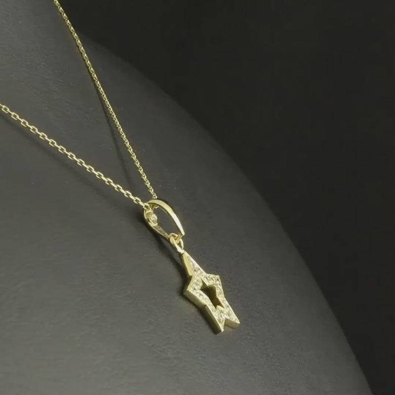 14ct gold star pendant with clear cubic zirconia displayed on a fine gold chain, demonstrating its potential look when paired with a chain.