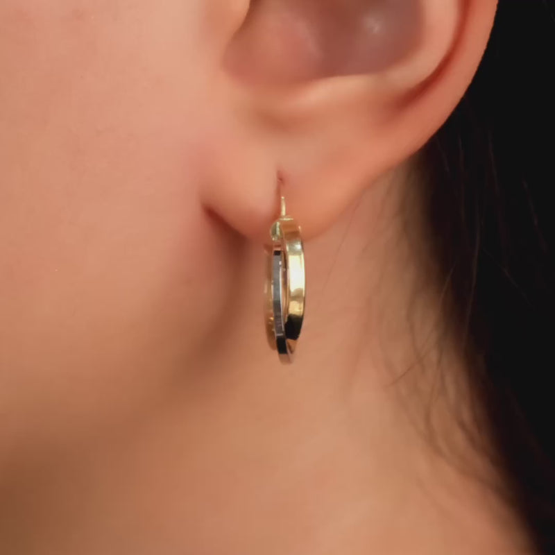 The earrings worn by a woman, demonstrating their elegant fit and versatile style