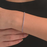 Woman wearing the 14ct white solid gold and CZ tennis bracelet.