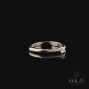 Kolié 9ct yellow gold solitaire ring with a round cubic zirconia, accompanied by a band of pave-set stones for a touch of radiance.