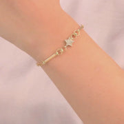 Video of 14ct gold bracelet worn on a woman's wrist, highlighting its elegant and sparkling design