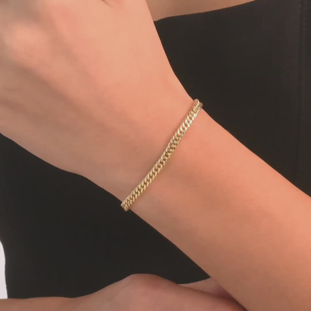 Woman wearing the 14ct gold curb chain bracelet, showcasing its elegant and minimalist style