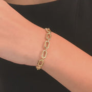 14k gold bracelet worn on a woman's wrist, highlighting its striking rectangular design and modern style.