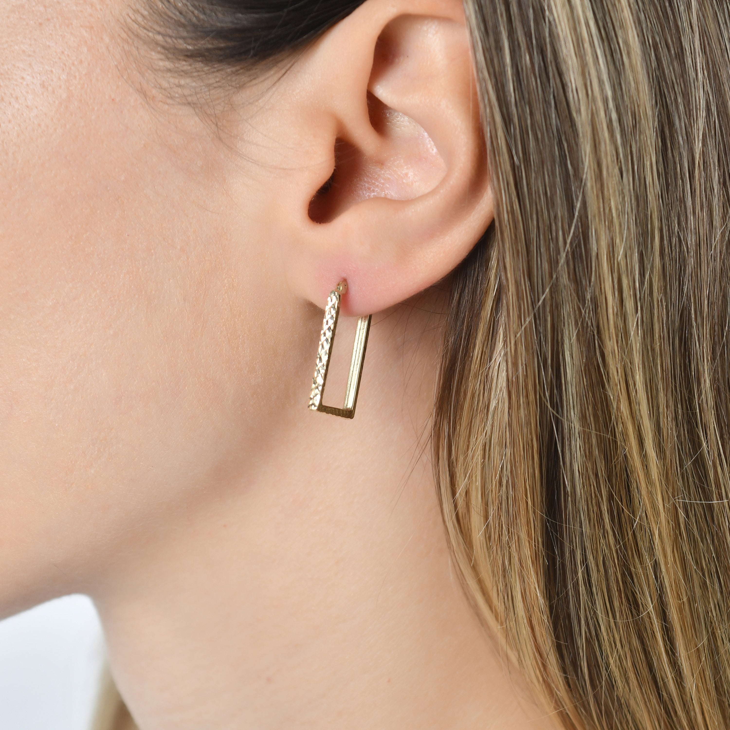 Close-up of Kolié 9ct solid gold textured square hoop earrings, featuring a unique square shape and a subtle textured finish.