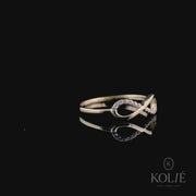 Kolié 9ct yellow gold ring displaying an infinity symbol with embedded cubic zirconia on a polished band.