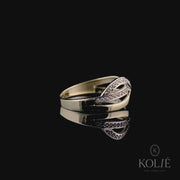 Kolié 9ct yellow gold crossover ring adorned with a stream of cubic zirconia, showcasing fluid elegance.