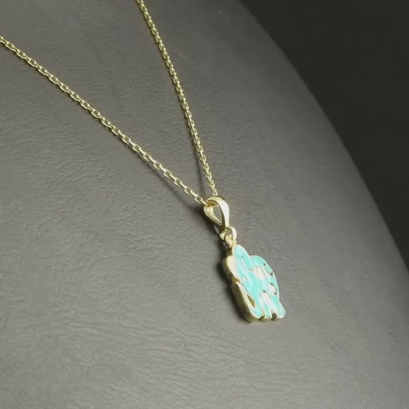 Elephant 14ct gold pendant, highlighting the vibrant blue enamel and gold craftsmanship