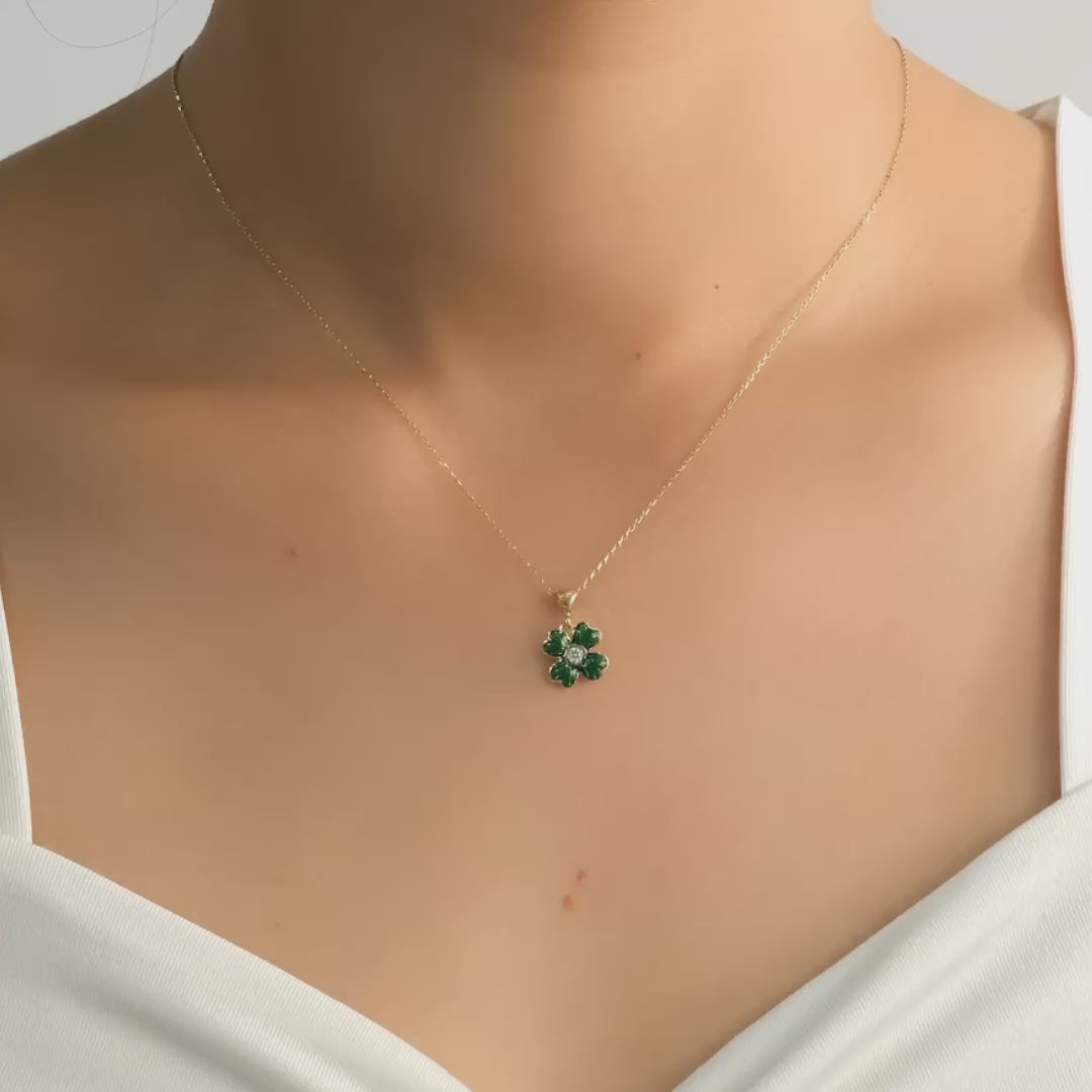 Video of gold clover pendant on a model