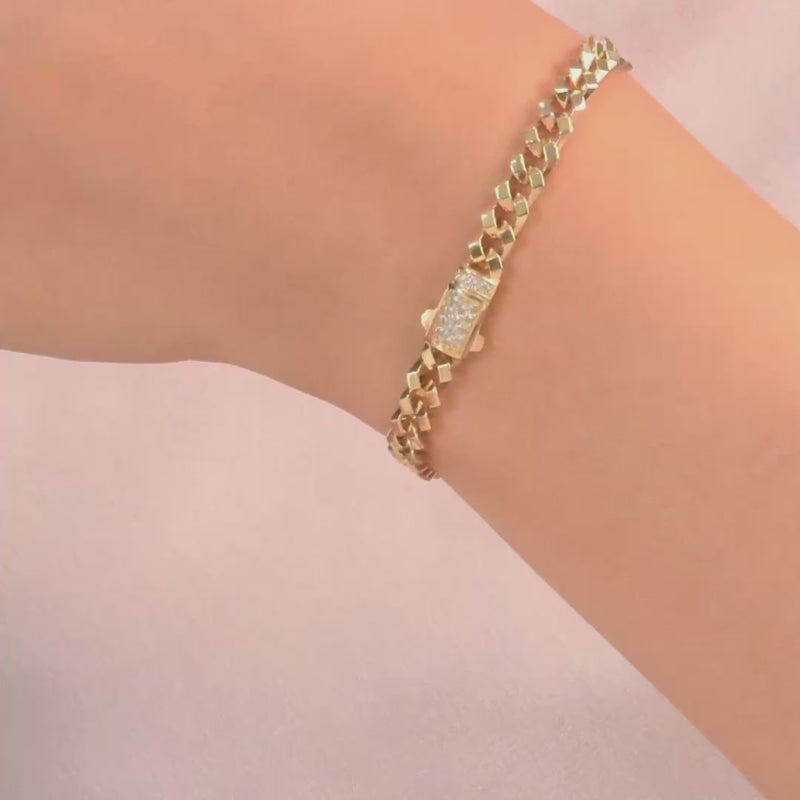 The bracelet worn on a wrist, highlighting the elegant gold and cubic zirconia combination.